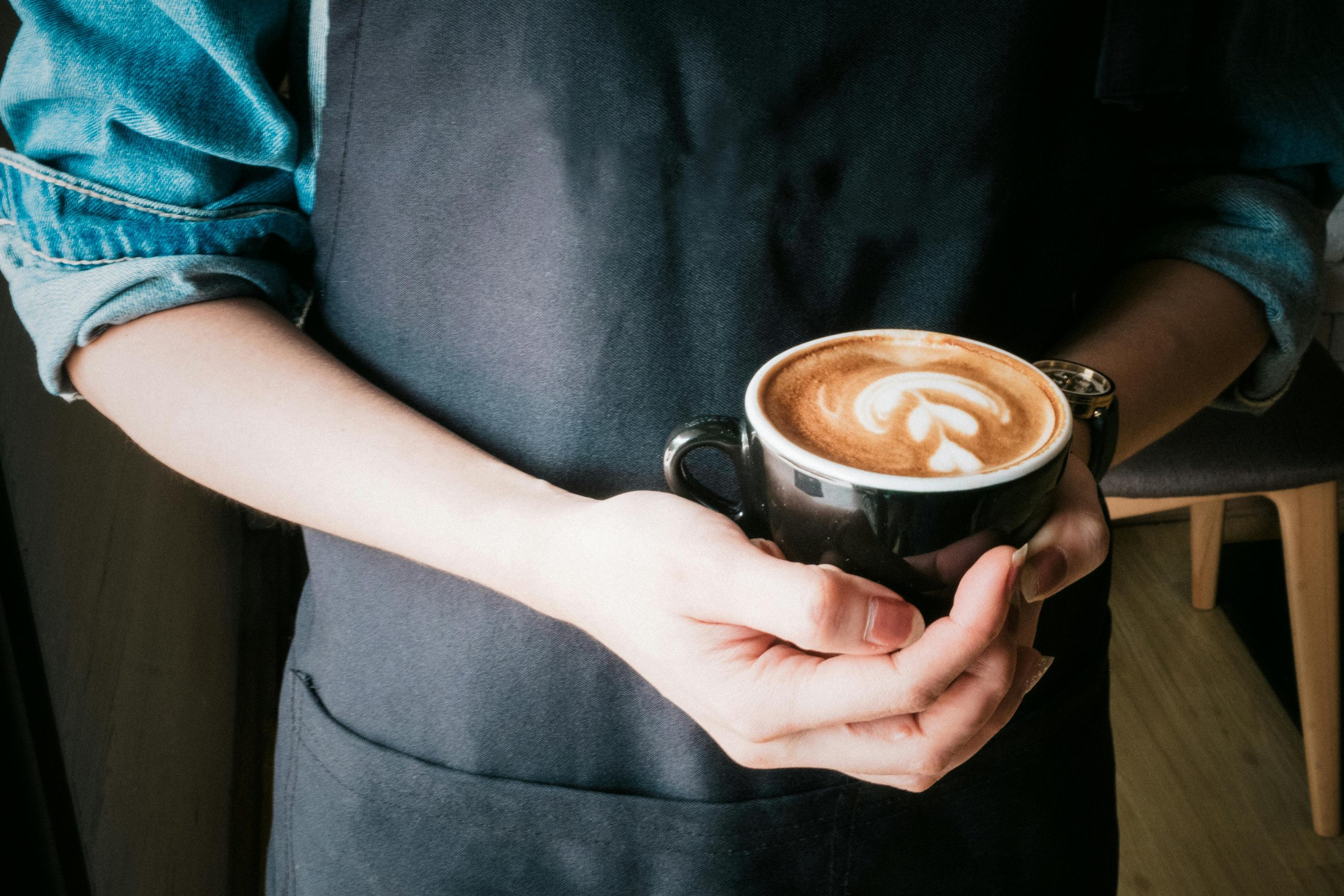 Coffee cup on desk representing strategic caffeine timing for shift workers