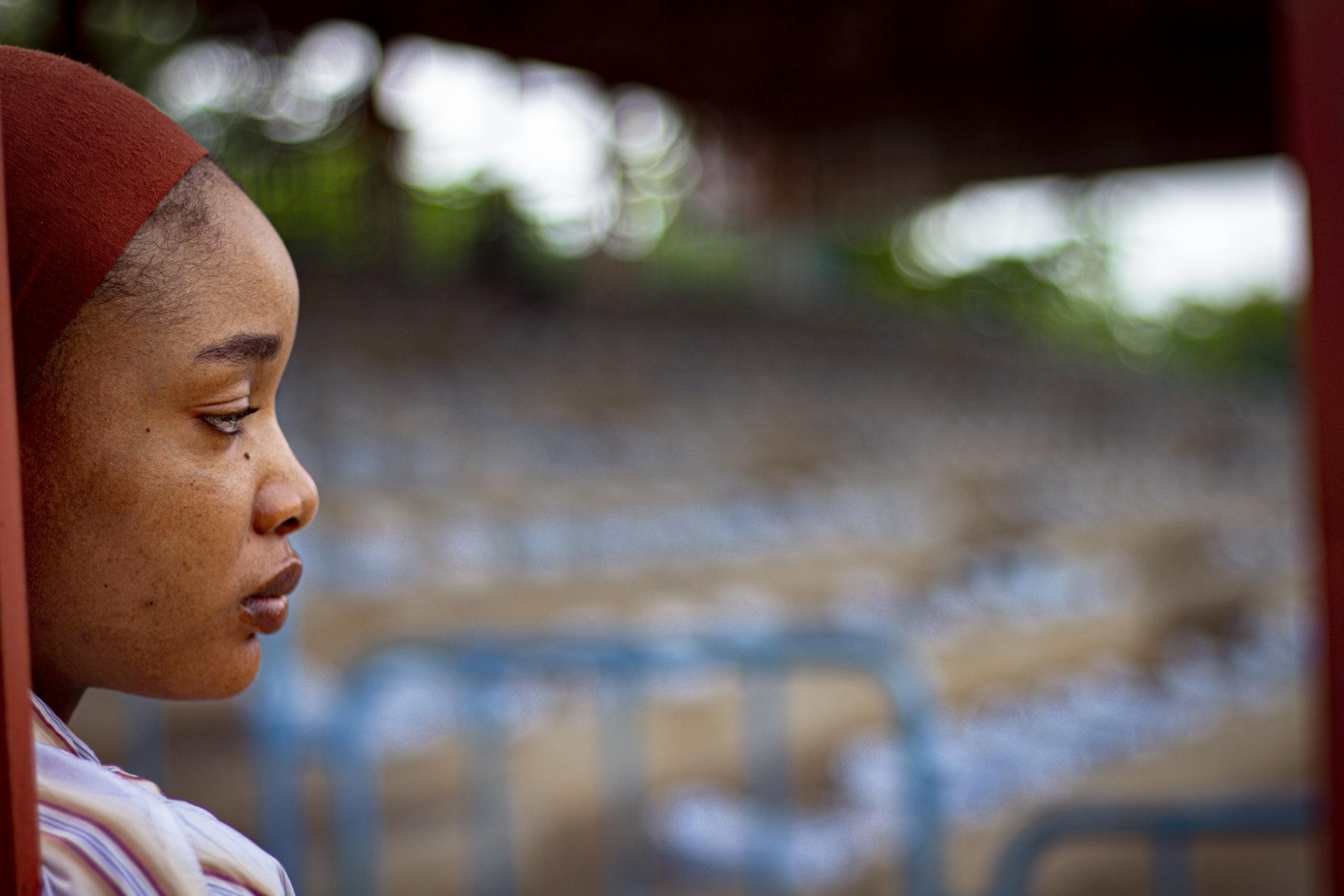 Contemplative woman in peaceful outdoor setting representing wellness and mindful health tracking