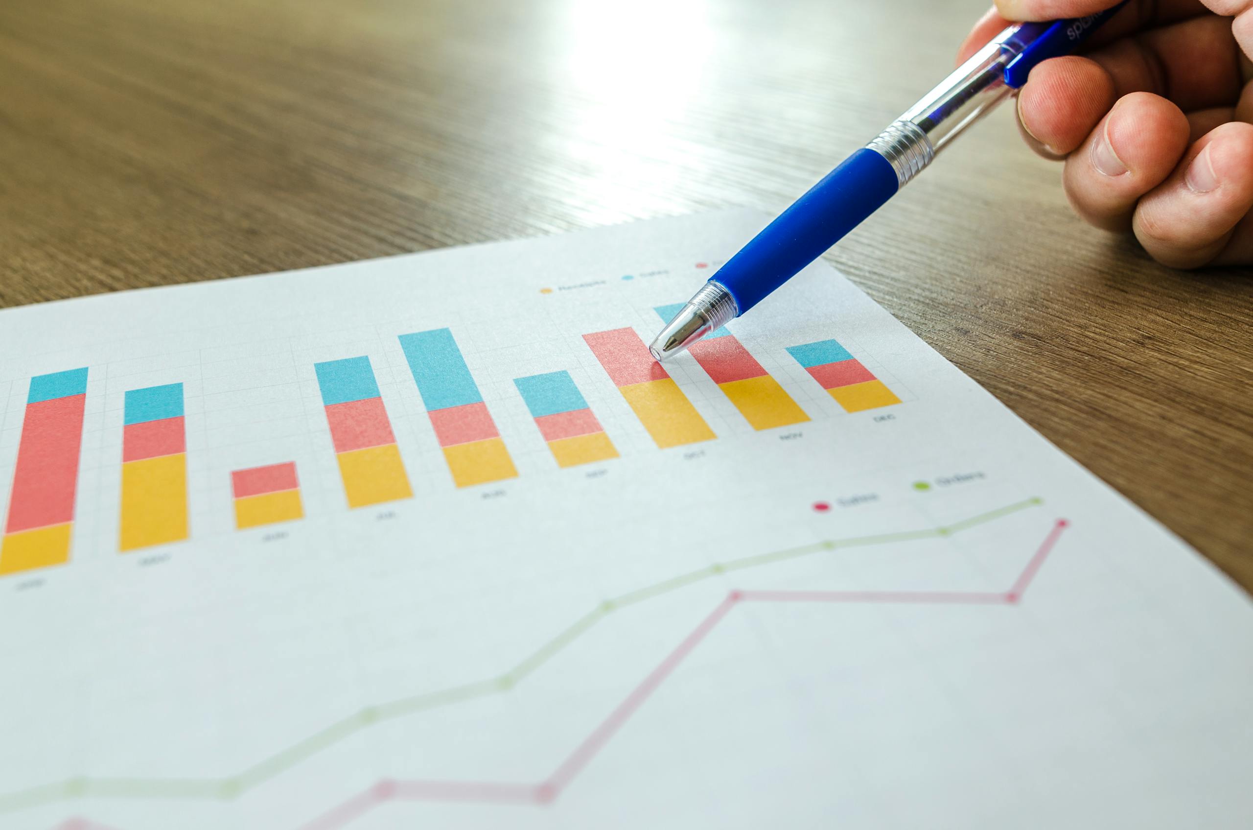 Close-up of hand reviewing sleep metric charts and performance data analysis