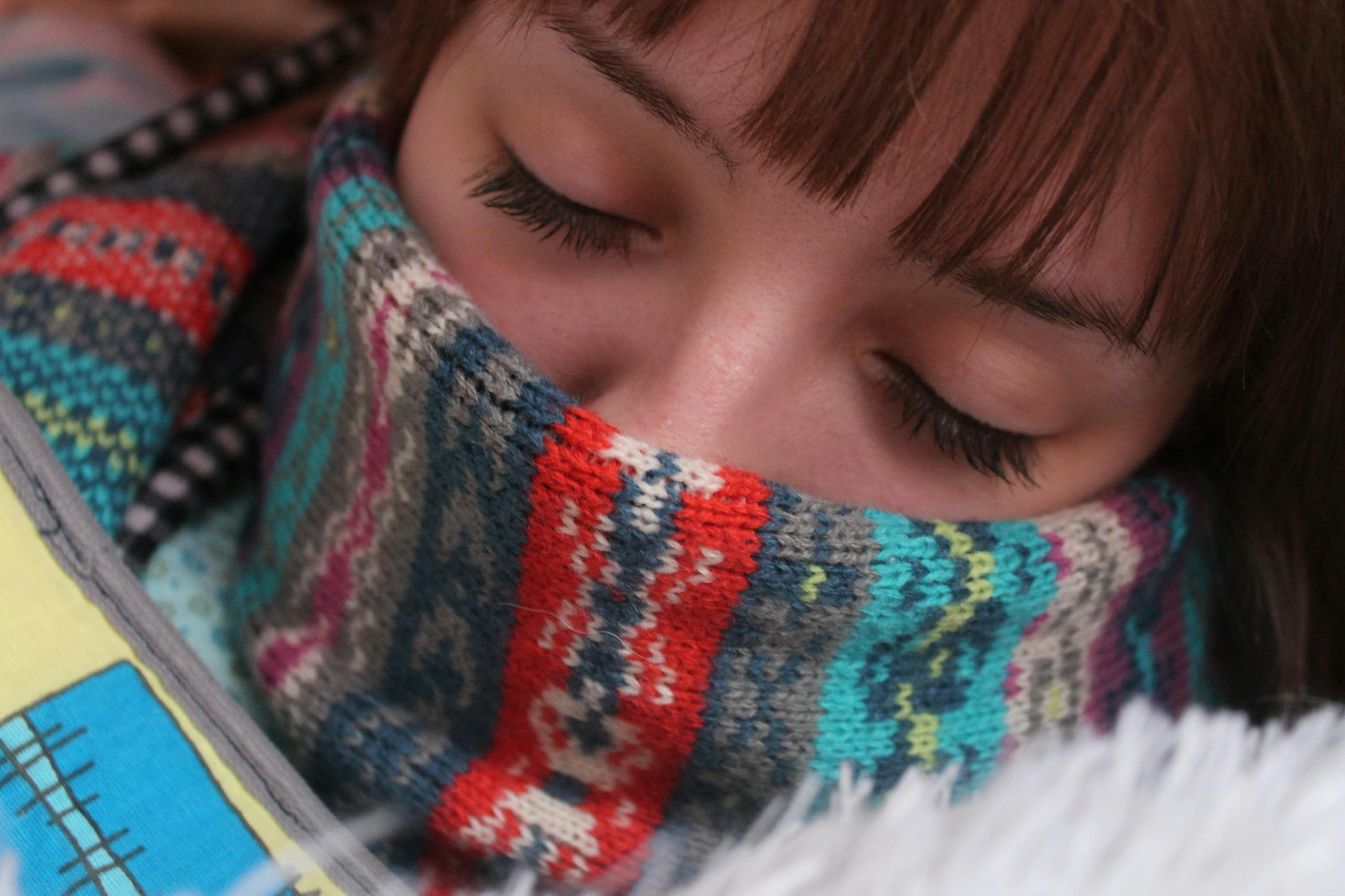 Woman resting peacefully wrapped in comfortable warm clothing