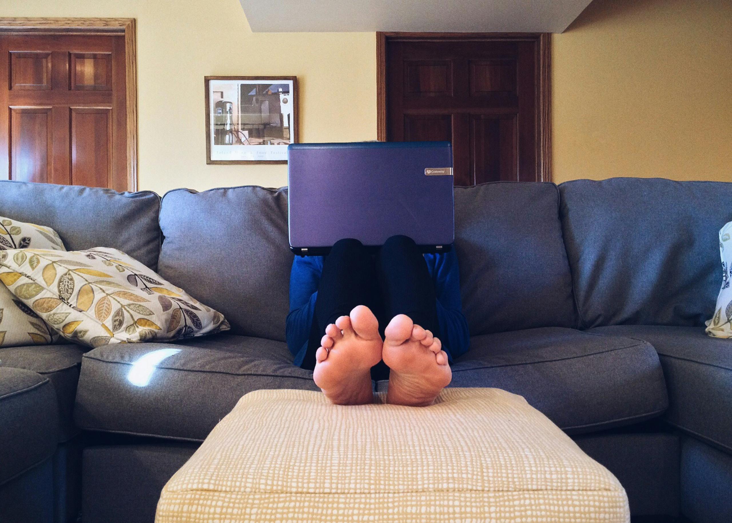 Person reviewing sleep tracking data on device in comfortable home setting