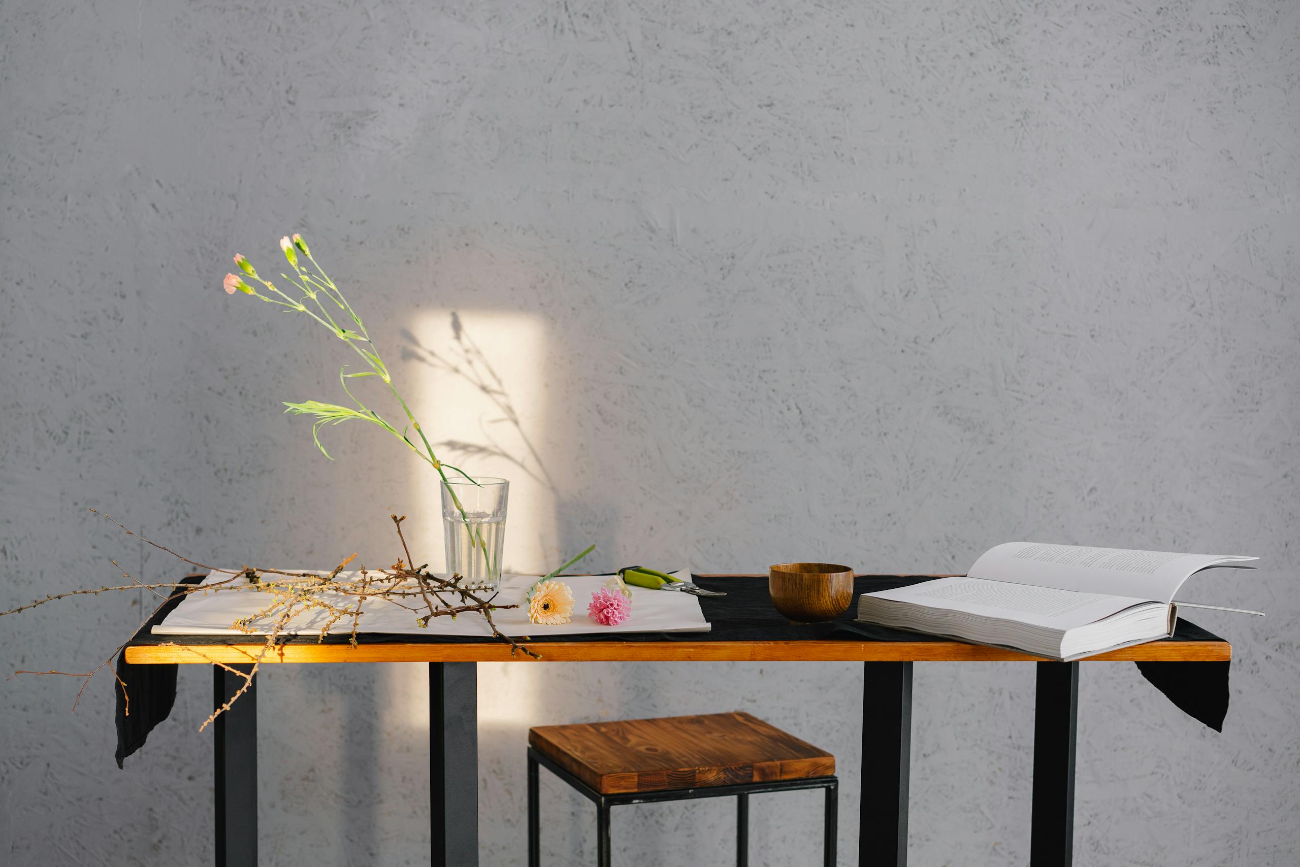 Minimalist table arrangement with natural elements creating calm relaxing atmosphere for wellness