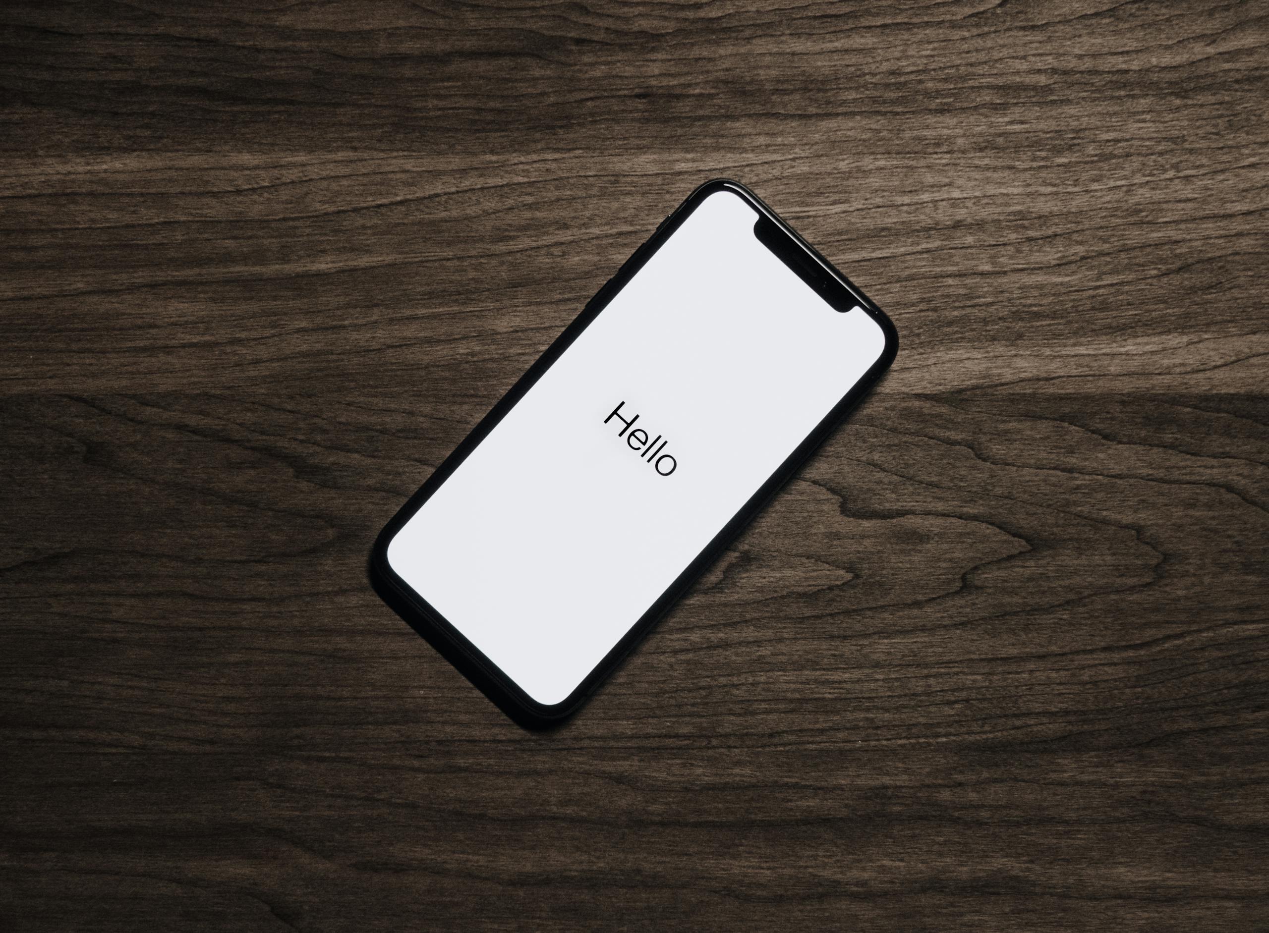 Smartphone on wooden surface showing modern technology for home automation