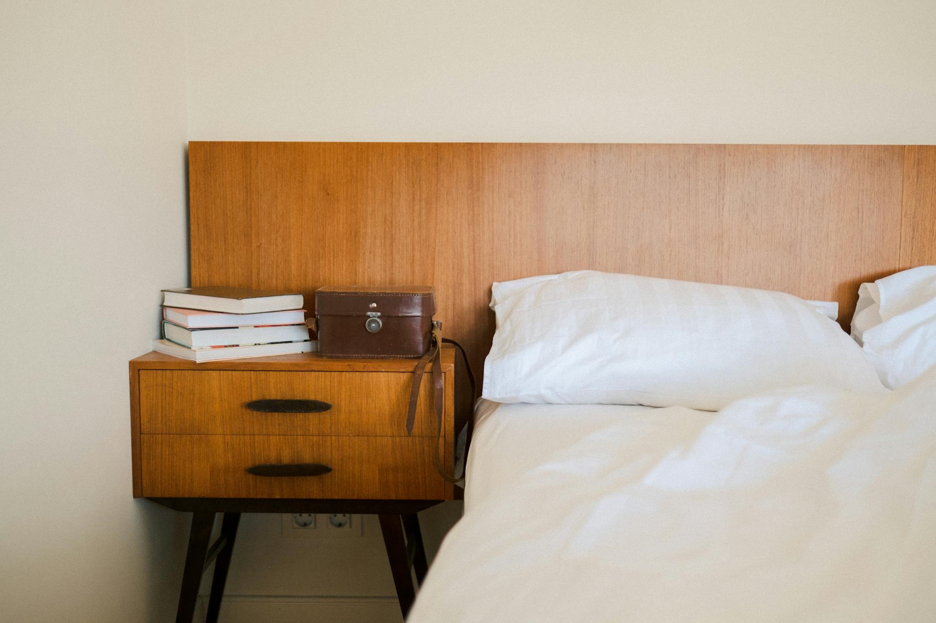 Portable white noise machine positioned on hotel nightstand ready for travel use