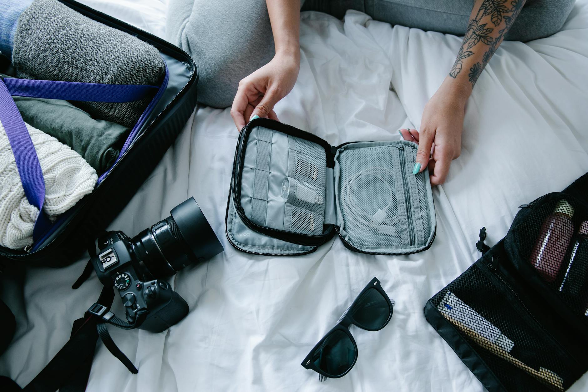 Travel essentials arranged for a trip including portable sleep accessories